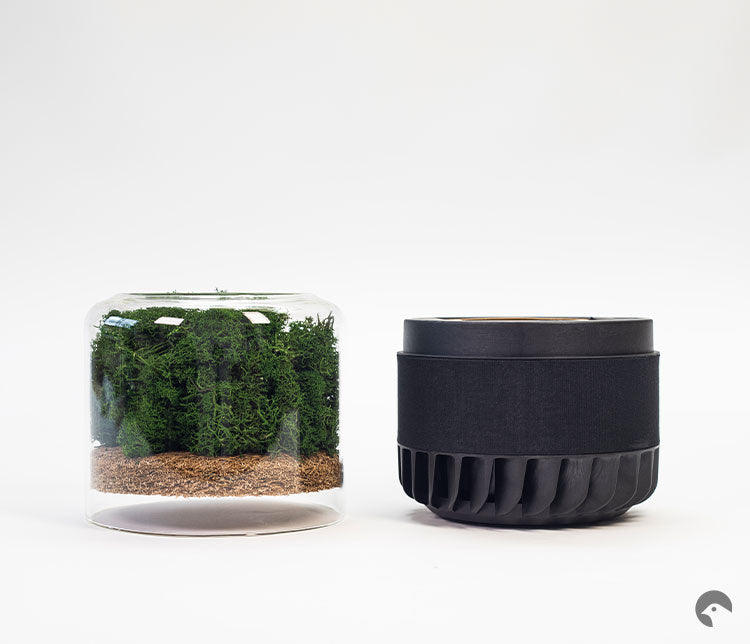 Deconstructed Briiv air purifier. On the left displays the glass case, Reindeer Moss filter and coconut filter; on the right displays the nano matrix filter and mechanical part of the appliance.